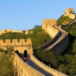 Sunny day at the Great Wall of China with tourists exploring the ancient landmark