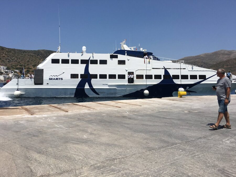 Greek SEAJETS ferry docked at Katapola port, Amorgos island, under clear blue sky.