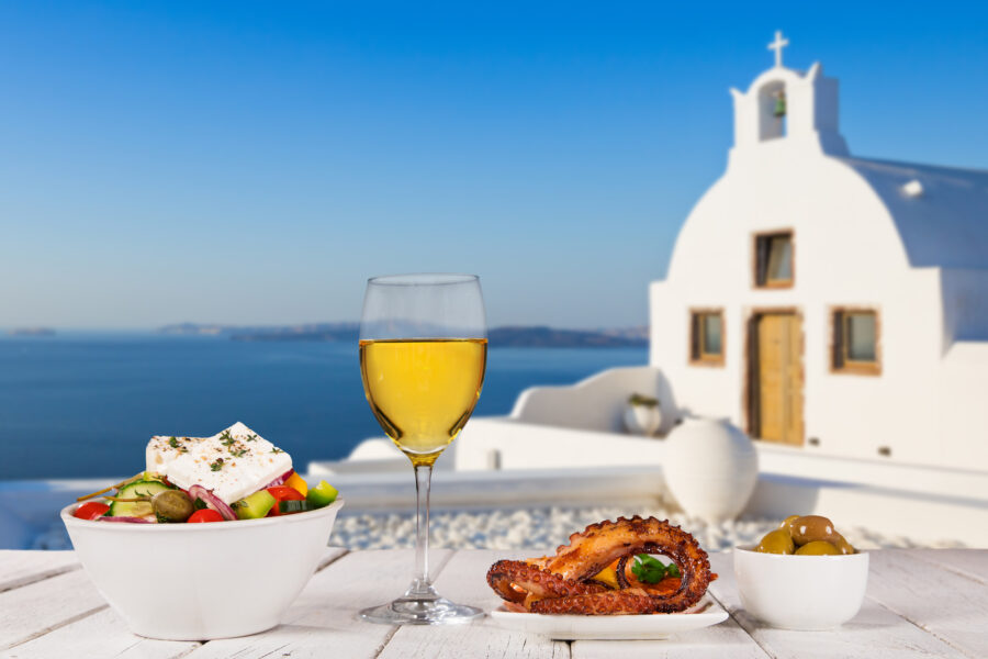Colorful spread of traditional Greek dishes, representing the rich culinary traditions of Santorini