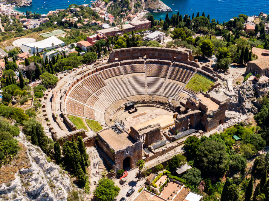 Aerial view of the Greek theater in Taormina, Sicily, showcasing its ancient architecture and surrounding landscape