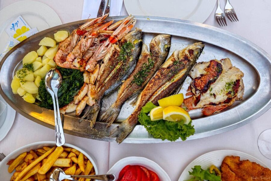 Grilled seafood platter with seabass, seabream, crayfish, calamari, fresh fish in Trieste, Italy.