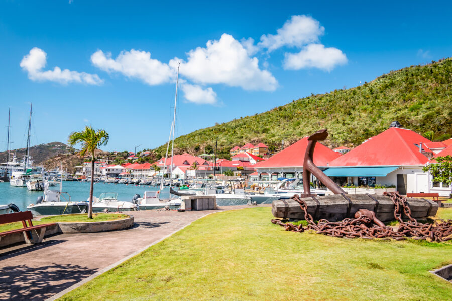 Harbor view of Gustavia, featuring red-roofed buildings in Saint Barthelemy, known as St Barts or St Barths.
