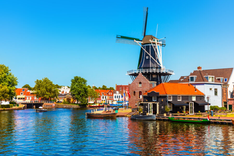 Historic buildings and canals in the Old Town of Haarlem, Netherlands, showcasing Dutch architecture and vibrant street life.