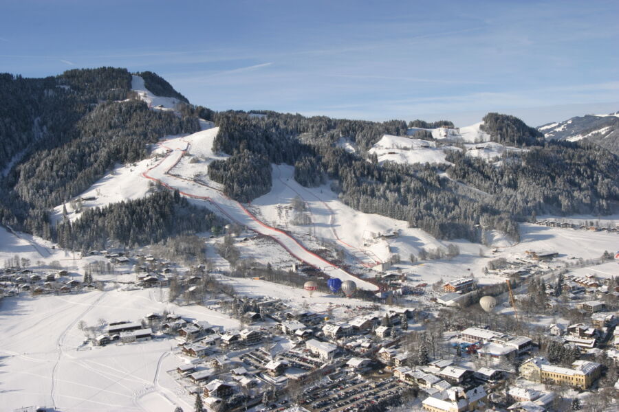 Aerial view of the Hahnenkamm Race in Kitzbühel, Austria, showcasing skiers racing down a snowy mountain slope