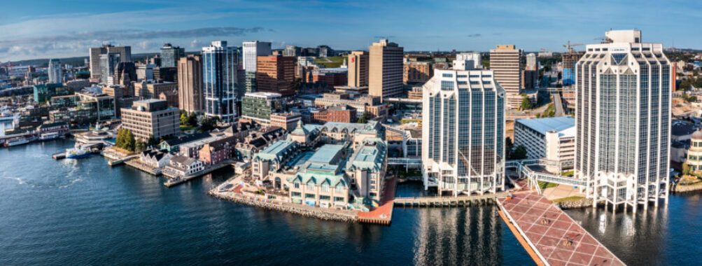 Aerial view of Downtown Halifax, showcasing modern waterfront buildings against a clear sky