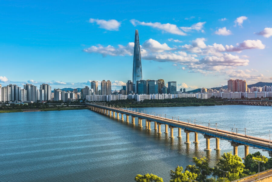 The Han River in Seoul, featuring a vibrant city skyline and green parks along the banks