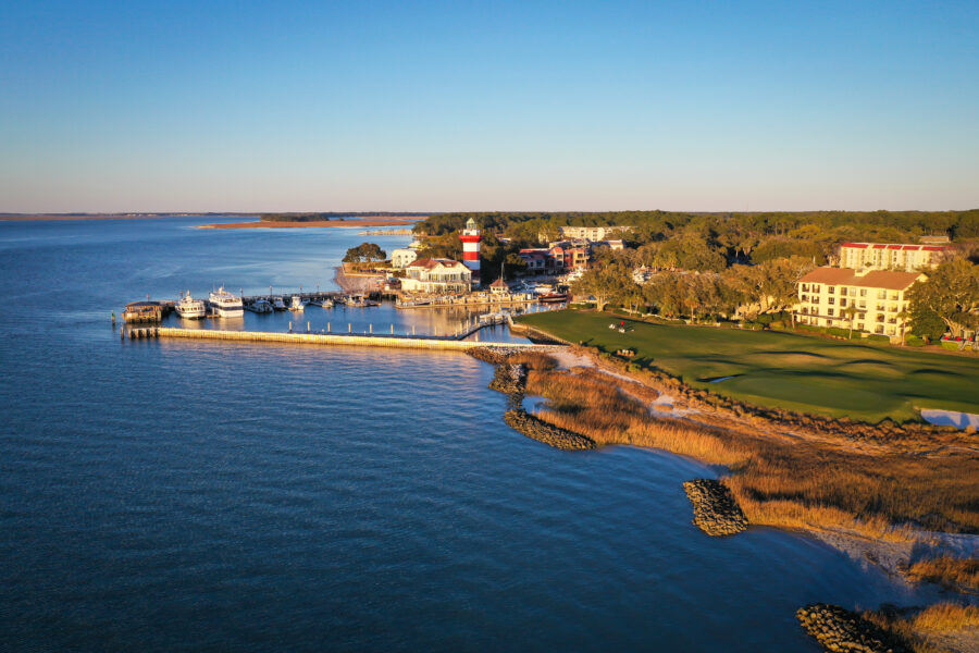 Sunset aerial view of Harbour Town and its iconic lighthouse, highlighting the scenic beauty of Hilton Head Island, South Carolina.

