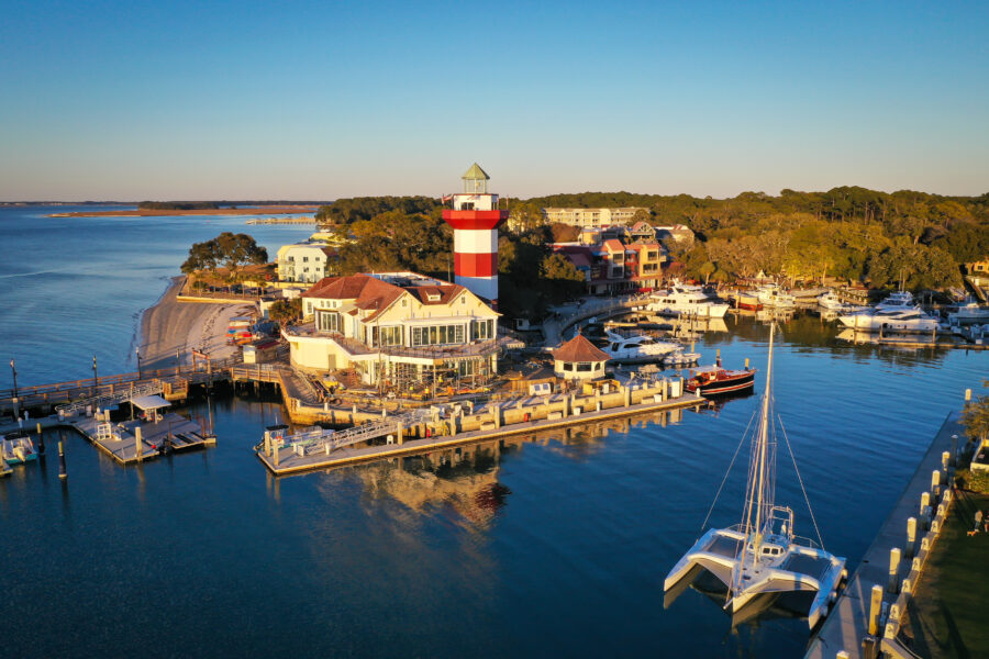 Aerial view of Harbour Town and its iconic lighthouse on Hilton Head Island, South Carolina, showcasing the coastal landscape.