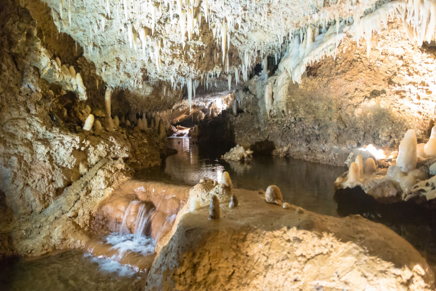 Inside Harrison's Cave, Barbados, featuring impressive stalactites and stalagmites in a serene underground environment