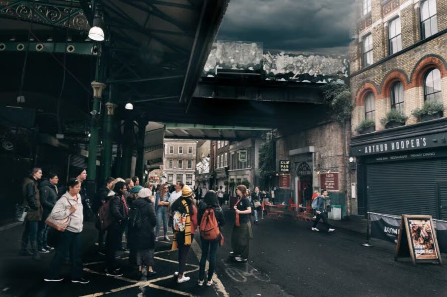 People stand in a city street under a dark sky, enjoying an interactive guided walking tour themed around Harry Potter.

