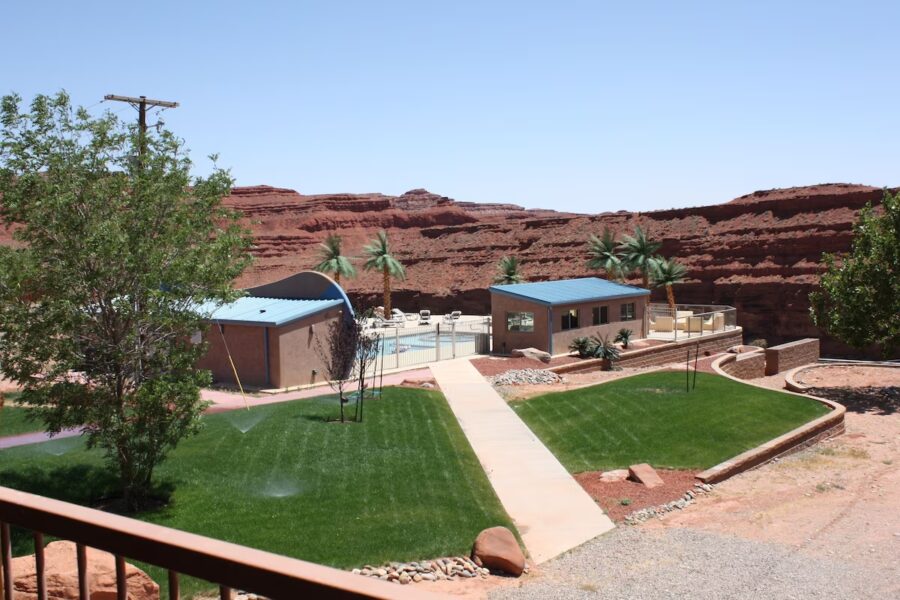 Balcony perspective of a house and pool at Hat Rock Inn, Utah, highlighting the serene outdoor setting.