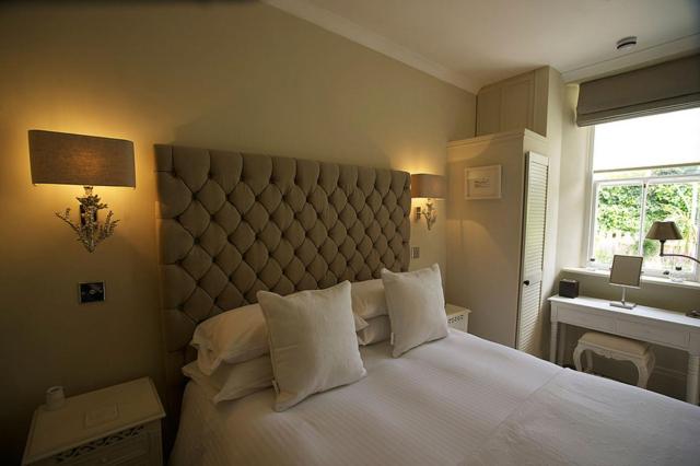 Stylish beds in a welcoming room at Headland House Luxury B&B, part of the White Horse Hotel in Cornwall, England.
