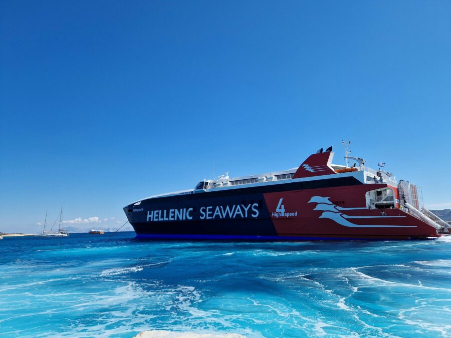 Hellenic Seaways high-speed ferry cruising turquoise Mediterranean waters, passenger ship against clear sky.