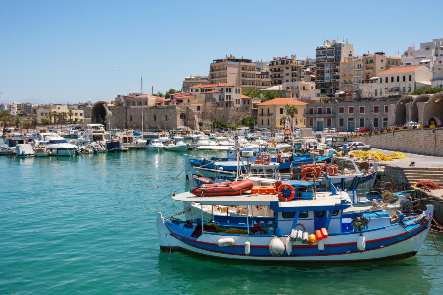 Bright blue sky dotted with white clouds over the scenic Heraklion Venetian Harbor