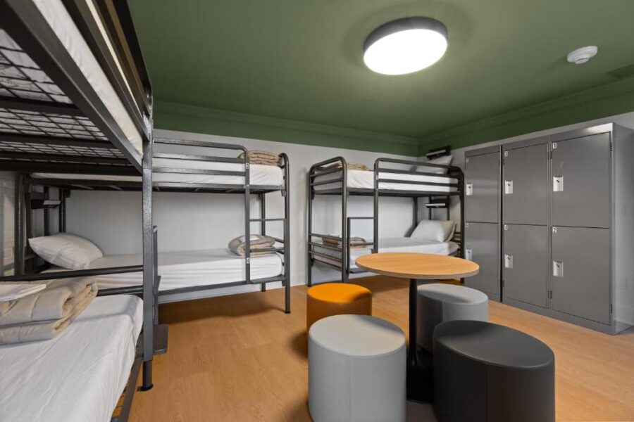 Interior of HI Halifax Heritage House Hostel featuring a bunk bed, table, and chairs.
