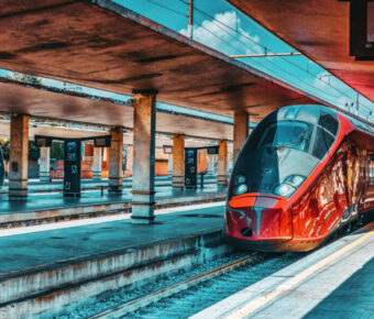 Sleek high-speed train stands at Firenze Santa Maria Novella station, showcasing modern rail travel in Italy.