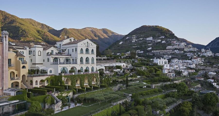 Luxurious Belmond Hotel Caruso on hillside with Mediterranean architecture and breathtaking natural landscape.