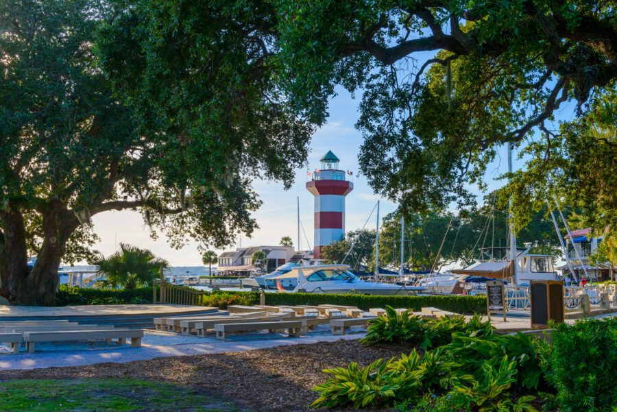 The harbor in Hilton Head Island, South Carolina, showcasing a lighthouse and boats, with a picturesque waterfront scene.