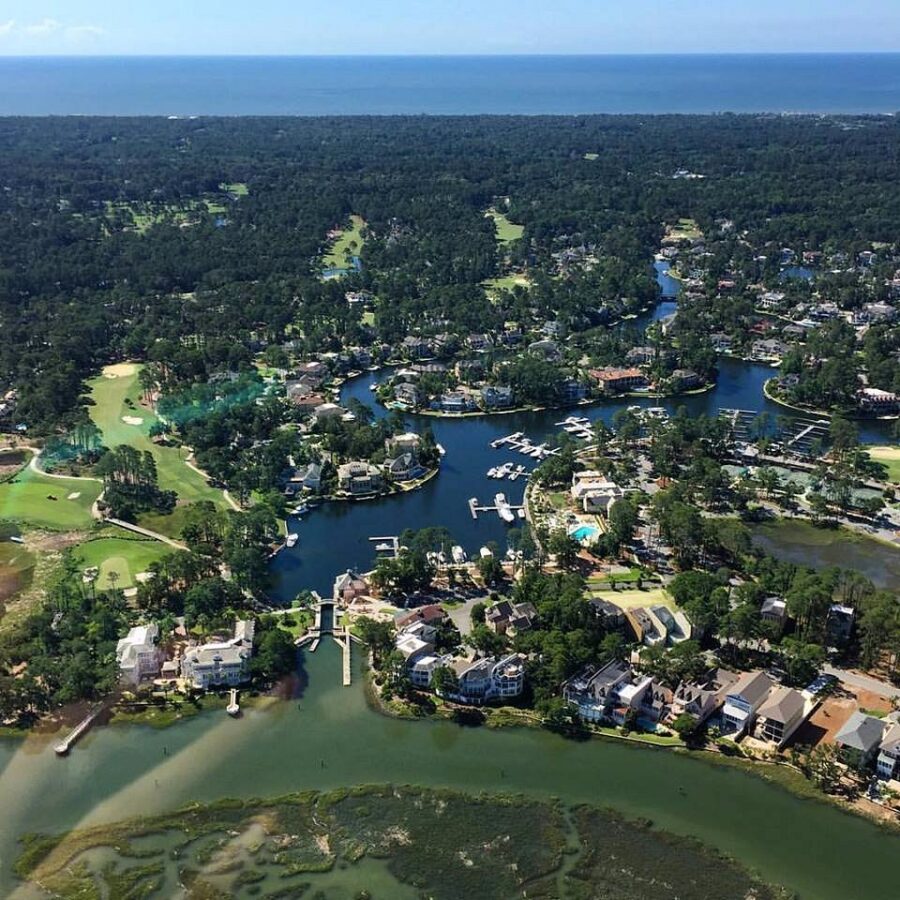 Aerial view of Hilton Head Island, showcasing a golf course alongside a winding river in South Carolina.
