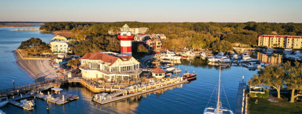 Aerial view of Harbour Town and its iconic lighthouse on Hilton Head Island, South Carolina, showcasing the coastal landscape.