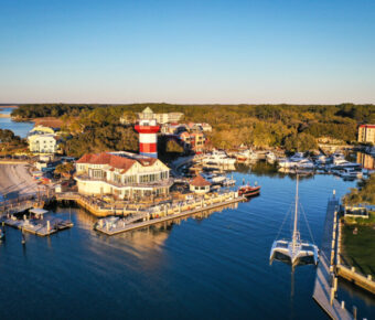Aerial view of Harbour Town and its iconic lighthouse on Hilton Head Island, South Carolina, showcasing the coastal landscape.