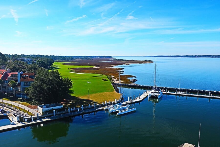 Picturesque marina with waterfront houses, set against the backdrop of Hilton Head Island, South Carolina.