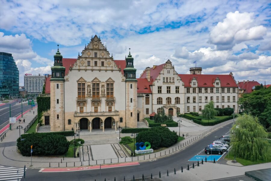 Adam Mickiewicz University historic red-roofed academic building, ornate facade and turrets.