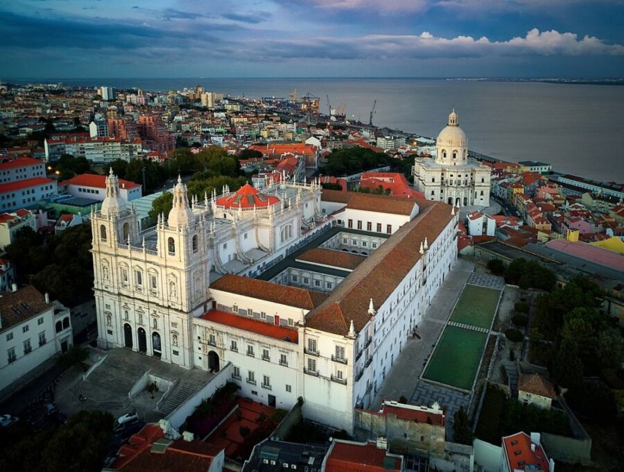 São Vicente de Fora Monastery aerial view overlooking Lisbon rooftops and Tagus River.