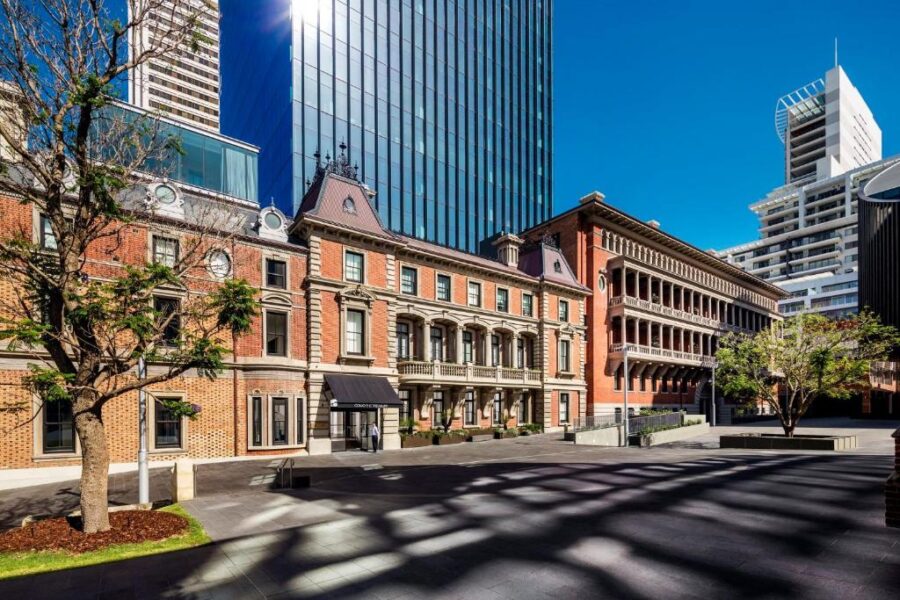 Historic Perth city plaza at COMO The Treasury, heritage brick buildings and modern glass skyscrapers.