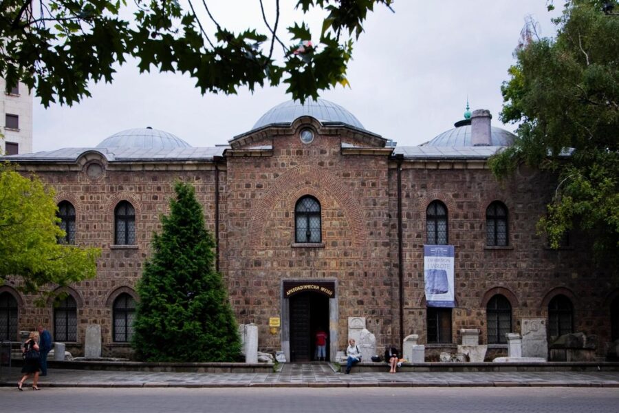 Historic stone façade of National Archaeological Museum with domes and archway entrance.