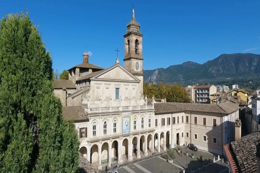 Historical church with bell tower in a picturesque town setting.
