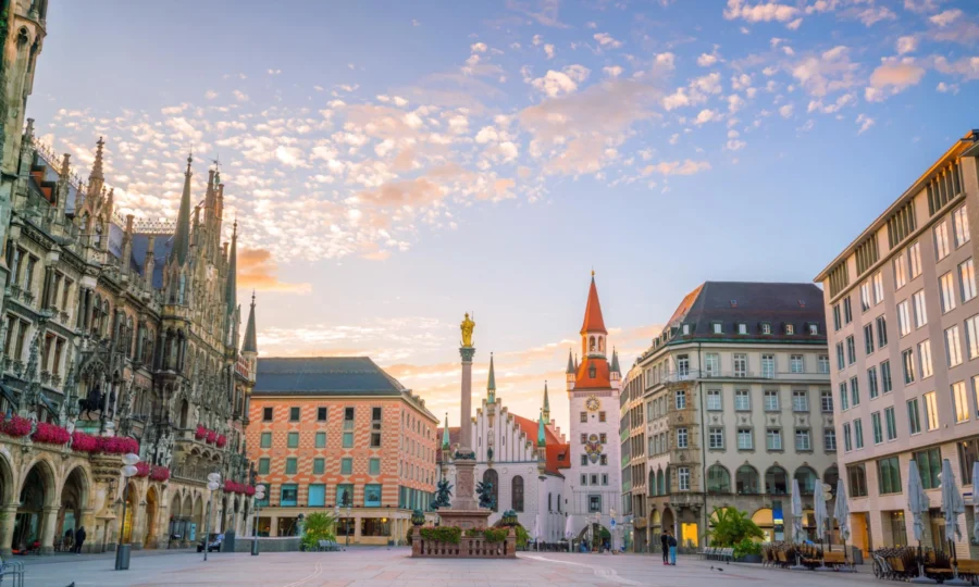 Vibrant Munich square blending historical architecture and modern elements at sunset.