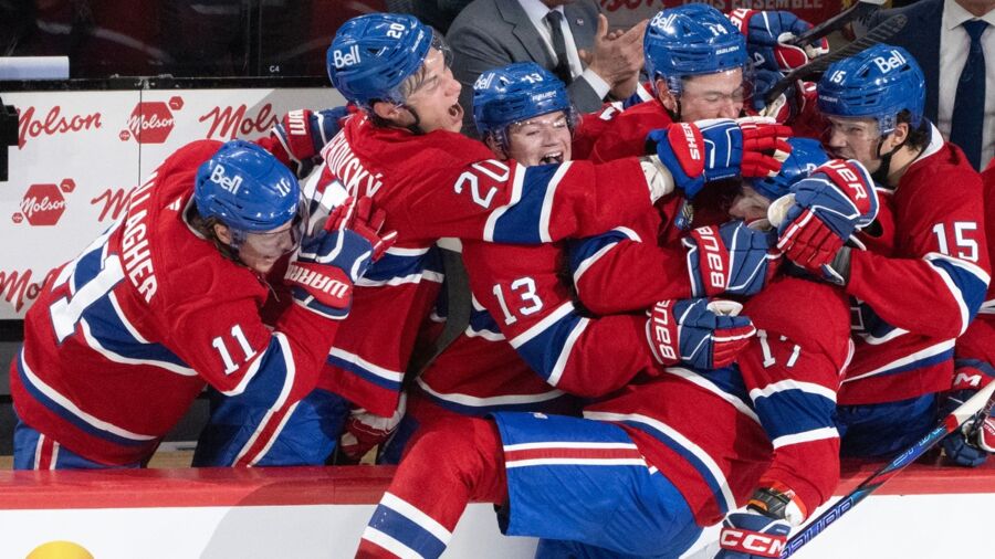 Montreal Canadiens players celebrate goal joyfully in iconic red, white, and blue uniforms.