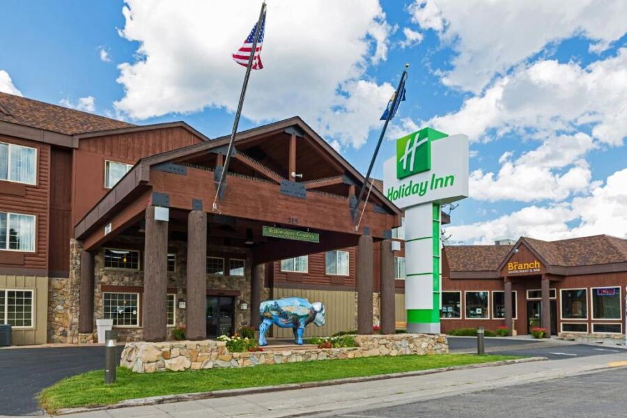 Holiday Inn West Yellowstone hotel exterior in Wyoming, featuring a modern design and surrounded by scenic landscapes.