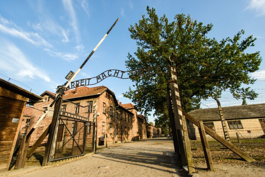 Entrance to the Auschwitz extermination camp, a Holocaust Memorial Museum near Krakow, Poland, featuring somber architecture.
