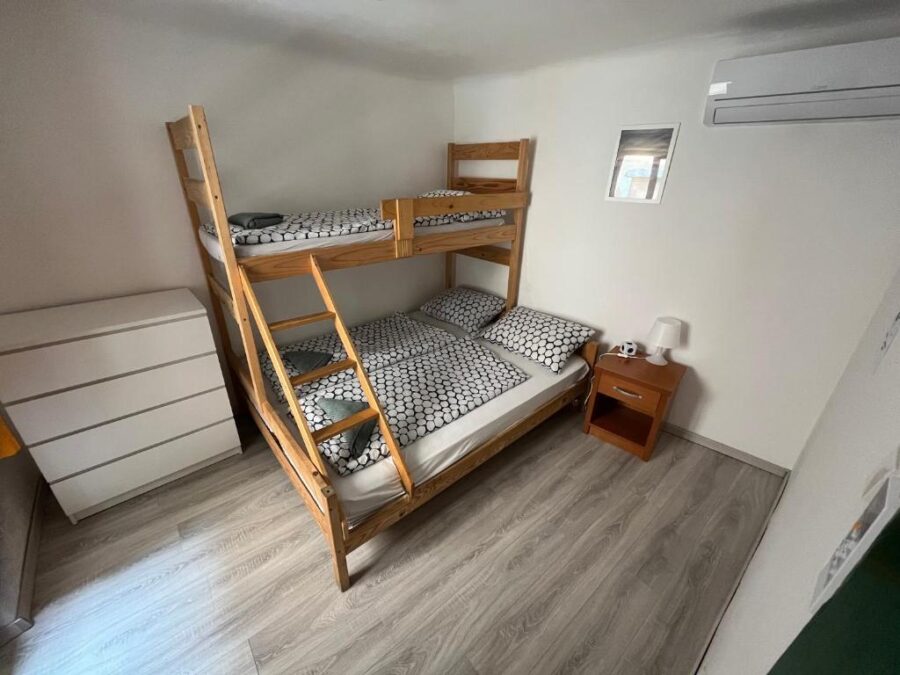 Bunk bed with two beds in a small room at Hostel Piran, Slovenia, showcasing compact accommodation.
