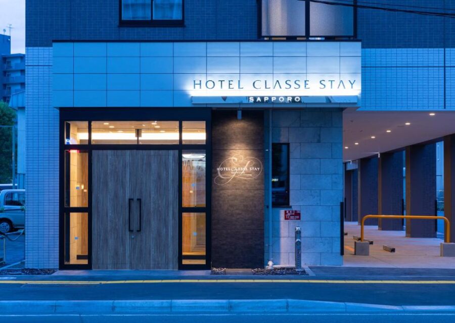 Night exterior of Hotel Classe Stay Sapporo entrance, modern illuminated hotel facade in Japan.