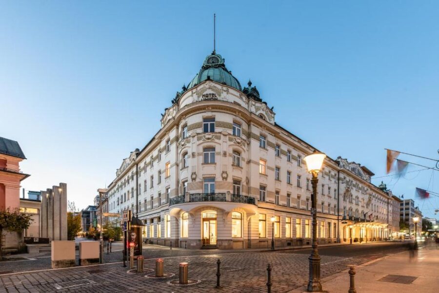 Grand Hotel Union historic corner at twilight with domed cupola and cobblestone street.