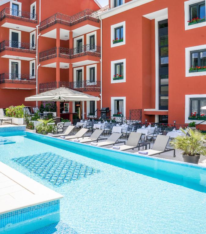Hotel Cvita in Split, Croatia, featuring a pool surrounded by lounge chairs for relaxation.