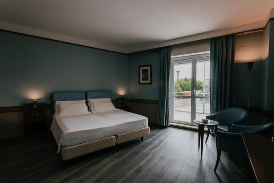 Hotel Del Campo room featuring a bed and a window, located in Matera, Italy.