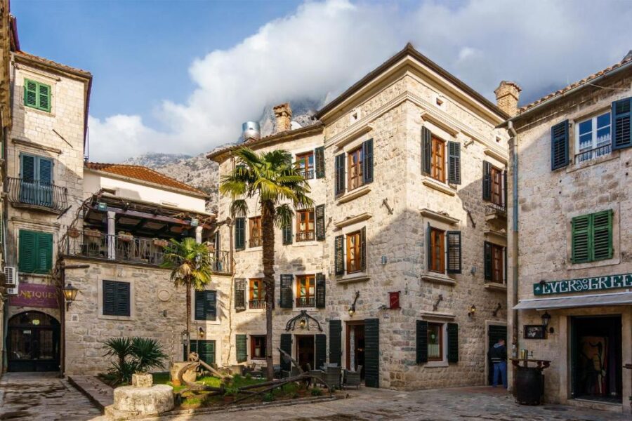 Historic Old Town Kotor, Montenegro, showcasing Hotel Monte Cristo and charming medieval buildings under a clear sky.