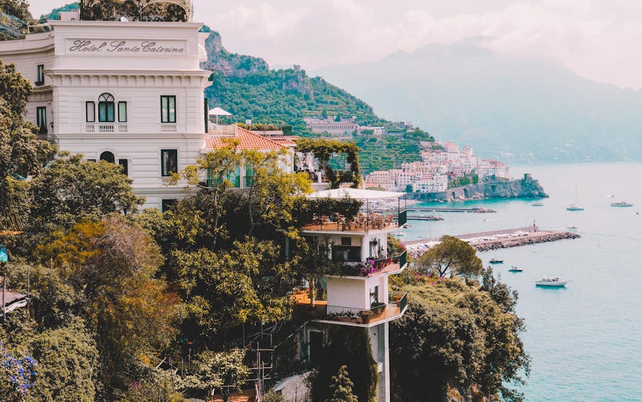 Scenic view of Hotel Santa Caterina on Amalfi Coast with sea, cliffs, and Mediterranean architecture.