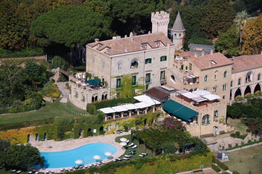 Scenic view of Hotel Villa Cimbrone in Italy, showcasing its elegant architecture and lush gardens overlooking the coastline.