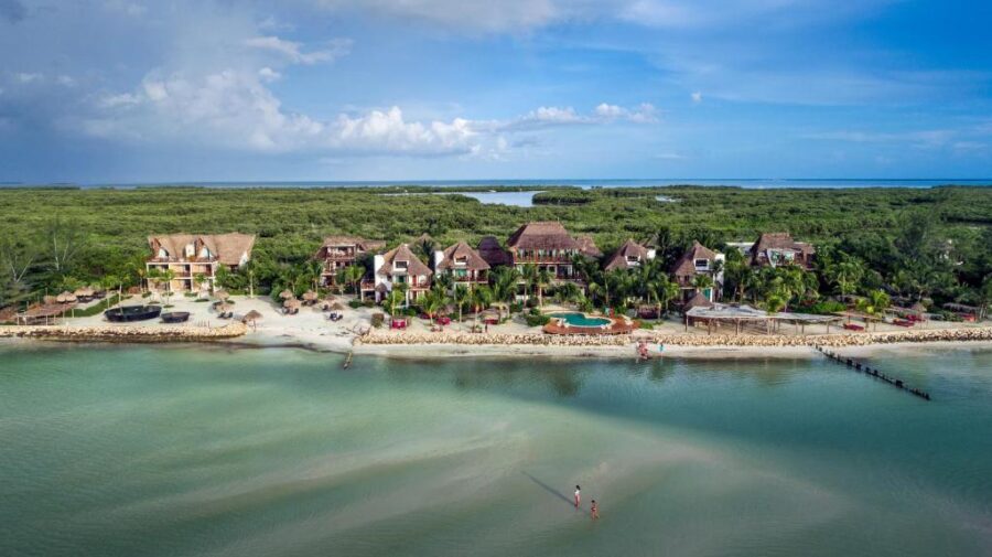 Aerial view of Hotel Villas Flamingos on Holbox Island, showcasing its beachfront location and surrounding turquoise waters.
