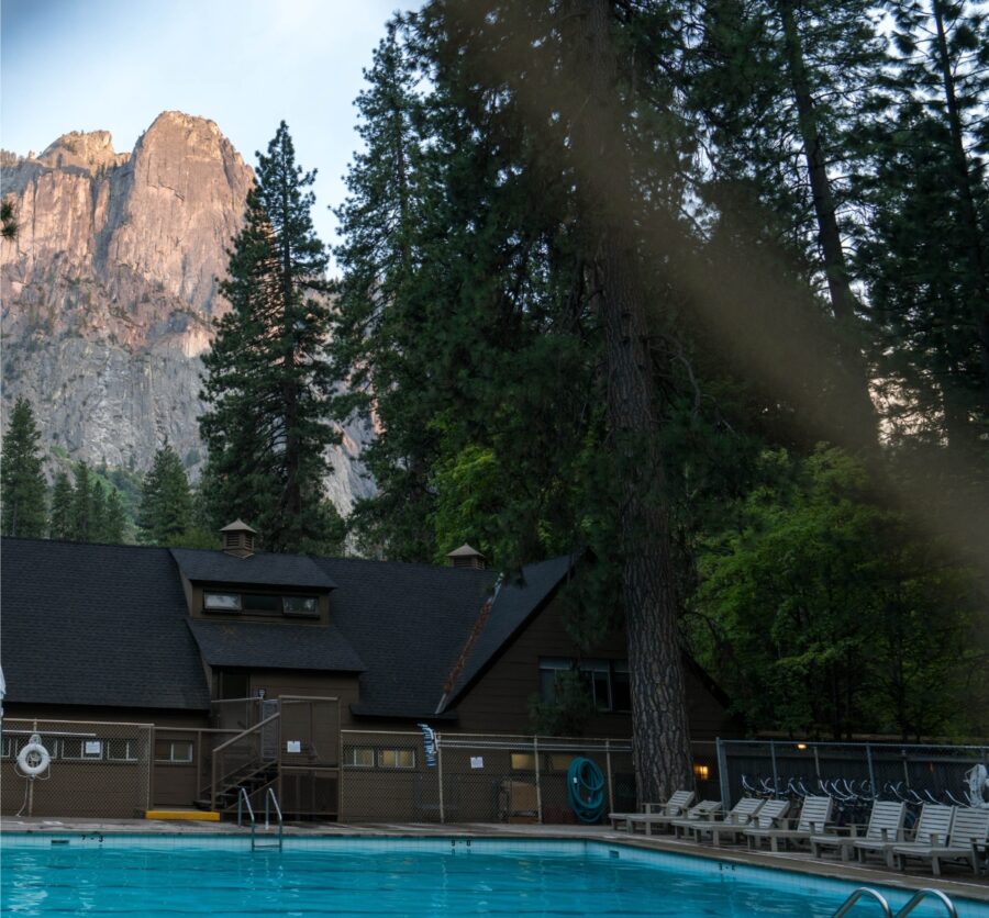Prominent mountain rises behind Housekeeping Camp, showcasing the natural beauty of Yosemite.