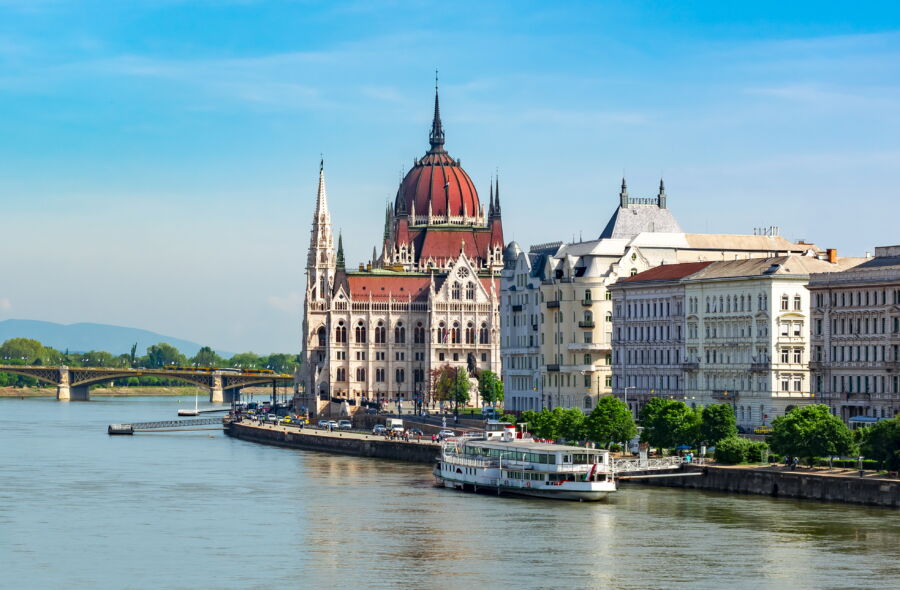 The majestic Hungarian Parliament Building in Budapest, highlighting its intricate architecture and grand dome by the riverbank