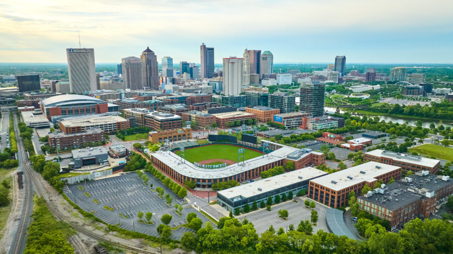 Aerial view of Huntington Park baseball stadium with the Columbus, Ohio skyline in the background.
