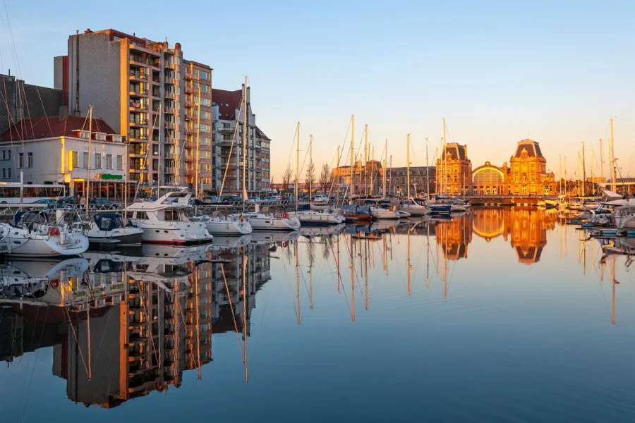 Ostend beach and pier skyline with seaside promenade and lighthouse, Belgium coastal city.