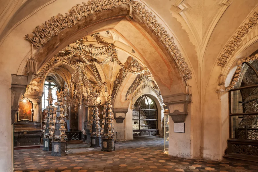 Sedlec Ossuary Bone Church interior with skulls and chandelier in Czech Republic.