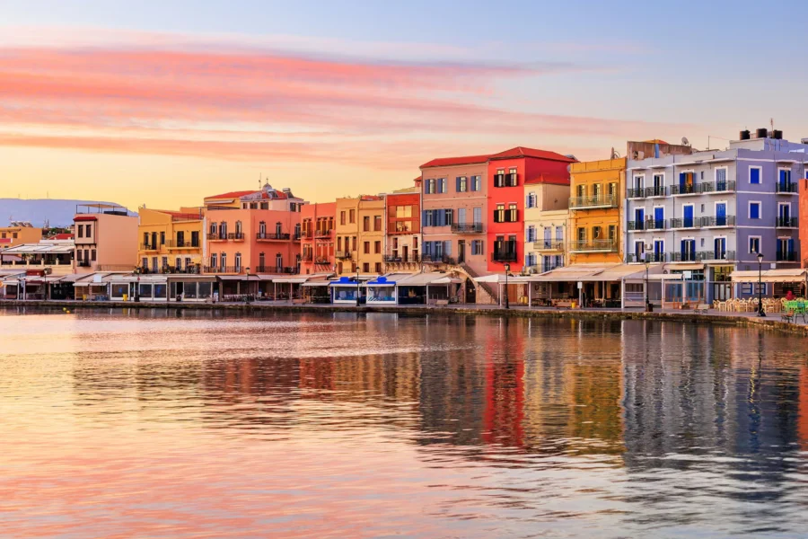 Chania harbor with Venetian lighthouse and colorful buildings, Crete, Greece travel photography.